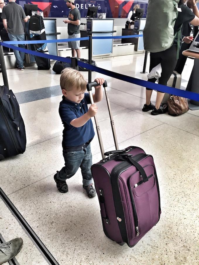 Tips For Flying With Young Kids 9 Toddler with suitcase