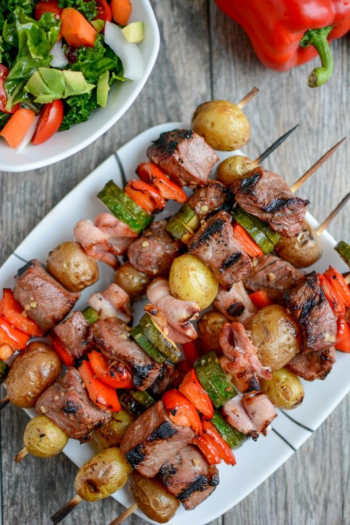Grilled Steak and Potato Kabobs with yellow potatoes, zucchini and bacon on a skewer
