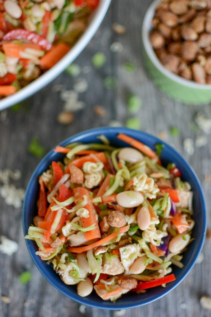 Broccoli slaw with ramen, topped with peanuts and green onions and and oil and vinegar dressing