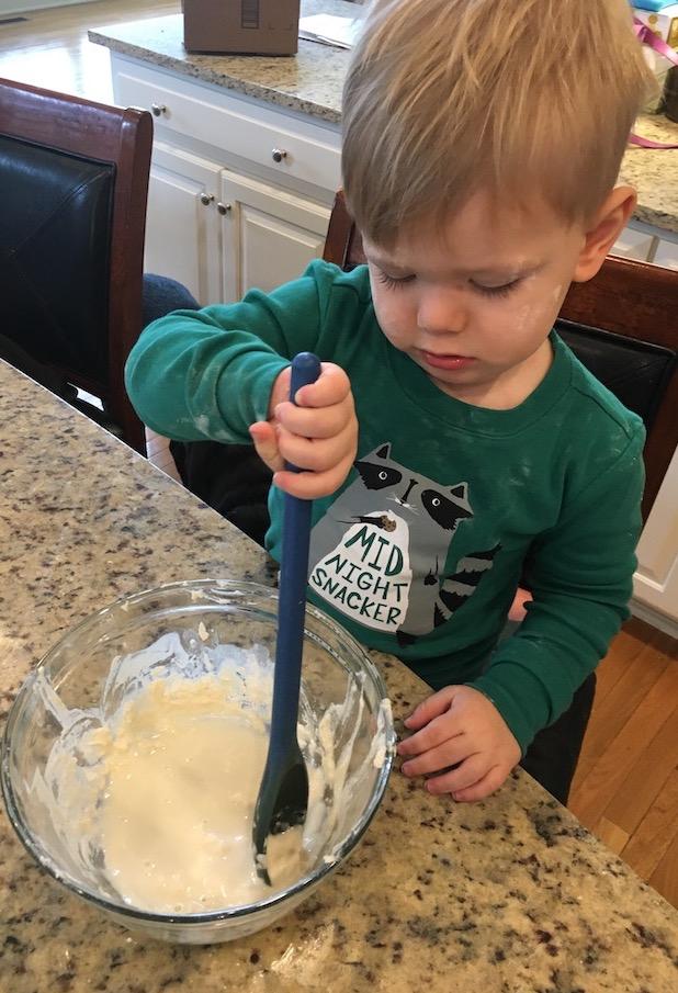 The Ultimate Guide to Teaching Kids To Cook 2 child stirring pancake batter