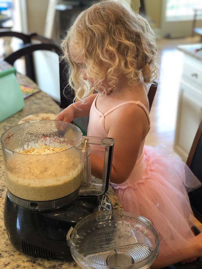 The Ultimate Guide to Teaching Kids To Cook 5 toddler making muffins with a food processor