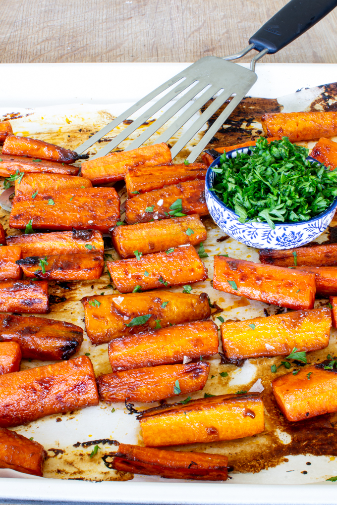 easy maple glazed carrots on a sheet pan with parsley