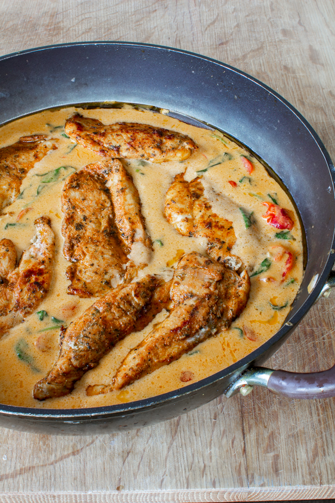 chicken in creamy tomato sauce with cherry tomatoes and spinach