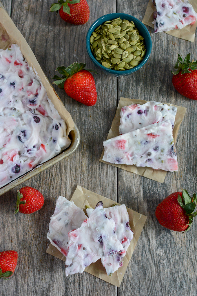 Frozen yogurt bark with strawberries, blueberries, chocolate chips and pepitas
